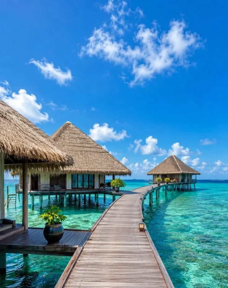 “Luxury Maldives overwater villas with crystal clear turquoise water and tropical island scenery”